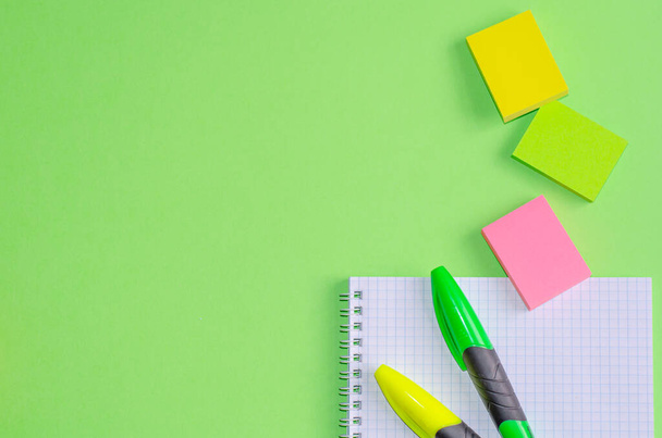 Back to school concept. School and office supplies on office table, green background. Flat lay with copy space. - 写真・画像