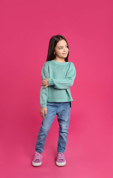 Cute little girl posing on pink background - Valokuva, kuva