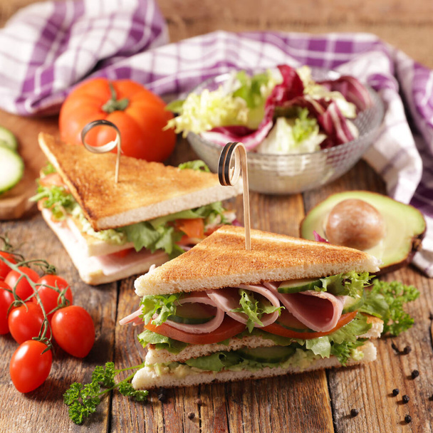 club sandwich- toasted sandwich with ham, tomato, lettuce and cucumber - Фото, изображение