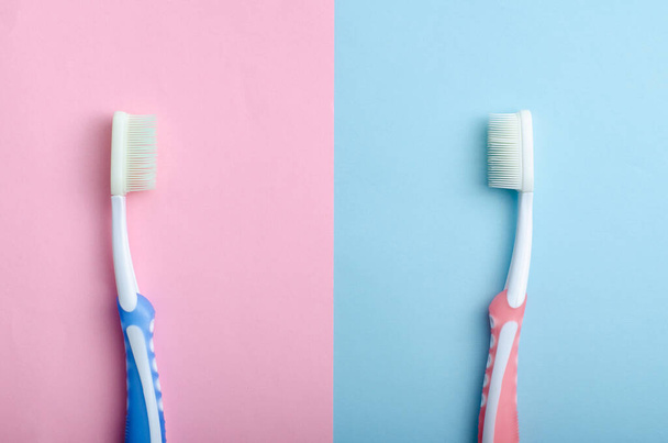 toothbrushes in love or upset on pastel colors as a man and woman - Foto, afbeelding