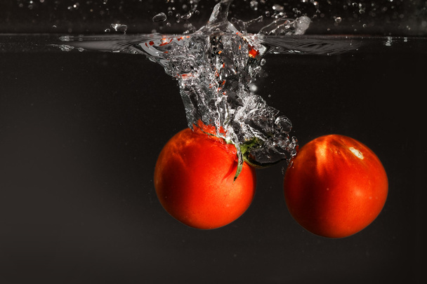Fresh tomato dropped into water - Photo, image