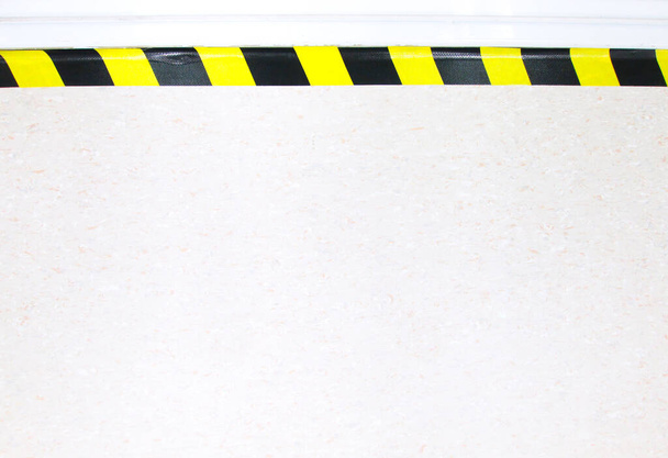 Warning hazard construction stripes sign or symbol texture isolated in granite concrete floor background, for safety first in laboratory walk way to watch out your step. Workplace safety concepts. - Photo, Image