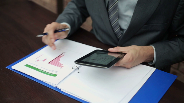 Businessman with tablet and documents - Video, Çekim