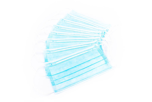 batch of disposable medical personal protective masks - used in COVID-19 global coronavirus pandemic SARS-CoV-2 - Photo, Image