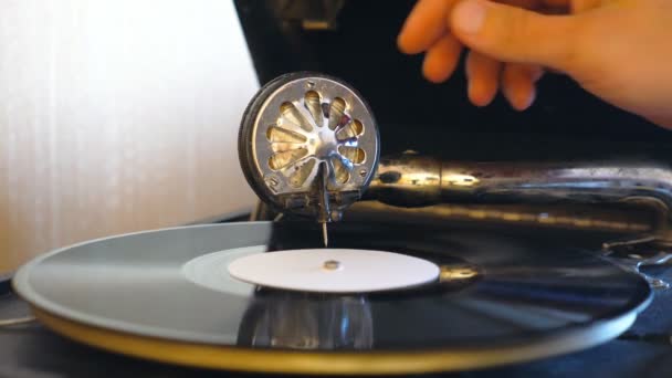 Detail view on needle sliding on black vinyl record spinning on retro turntable. Male hand taking stylus from vintage plate and turning off old gramophone. Retro concept. Slow motion Close up - Footage, Video
