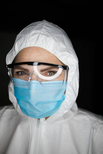 Close up portrait image of a health worker wearing protective clothing and masks working with Vaccines for dangerous viruses - Photo, Image