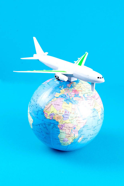 Plastic toy plane on the globe. Flight travel concept. Travel by airplane. Takeoff and landing of the aircraft. Return home from flight. empty Copy space. - Zdjęcie, obraz
