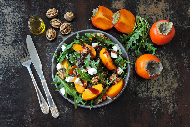 Salad with persimmon, arugula, white cheese and nuts. Keto diet. Keto lunch idea. Pegan diet. - Photo, Image