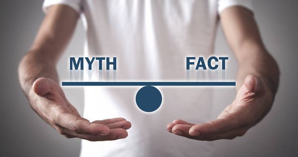 Man holding Myth and Fact balance. - Photo, Image