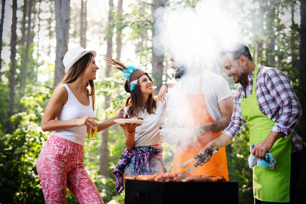 Friends having fun in nature doing barbecue - Photo, image