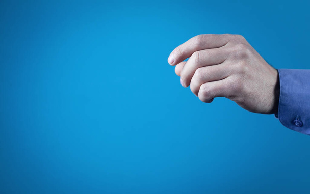 Man fingers to hold something. - Фото, изображение