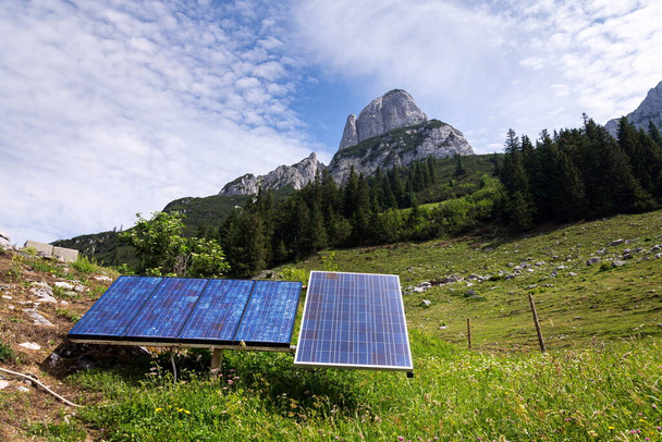 Solar panels with Strichkogel mountain between Grosser Donnerkogel and Angerstein in background, Alps, sunny summer day, clear blue sky, future innovation energy concept - Photo, image