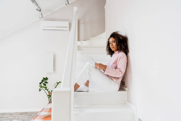 african american freelancer sitting on stairs with laptop  - Photo, Image