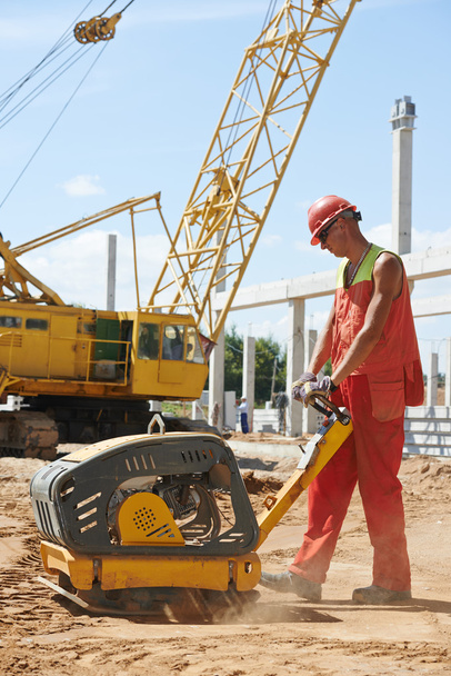 Worker with compaction machine - Foto, Imagem