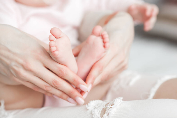 Close up still of baby`s feet. Little toes in mother`s hands. Baby concept. Maternity care. - Foto, afbeelding