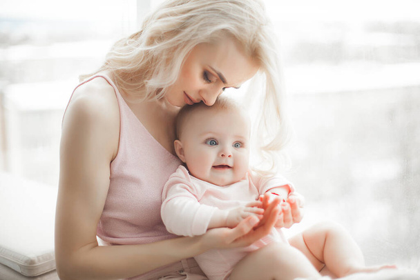 Young mother with little baby. Mommy holding her cute child. Maternity concept. - Valokuva, kuva