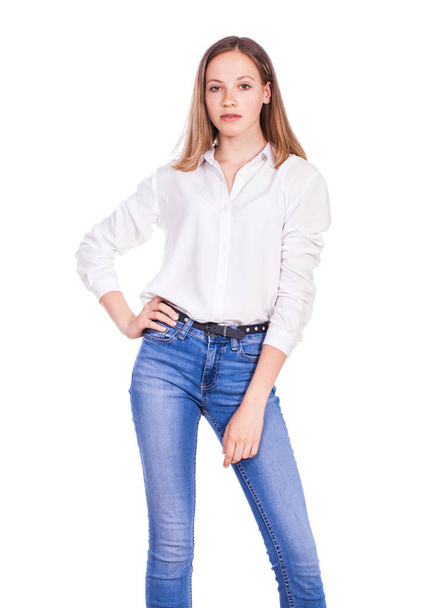 Close up portrait of a young beautiful blonde model in blue jeans and white shirt, isolated on white background - Фото, зображення