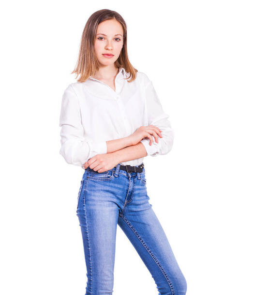 Close up portrait of a young beautiful blonde model in blue jeans and white shirt, isolated on white background - Φωτογραφία, εικόνα