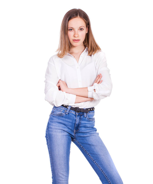 Close up portrait of a young beautiful blonde model in blue jeans and white shirt, isolated on white background - Foto, Imagem