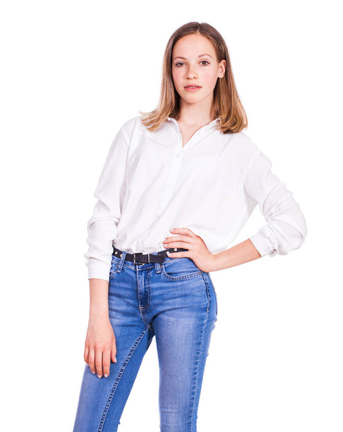 Close up portrait of a young beautiful blonde model in blue jeans and white shirt, isolated on white background - Foto, Bild