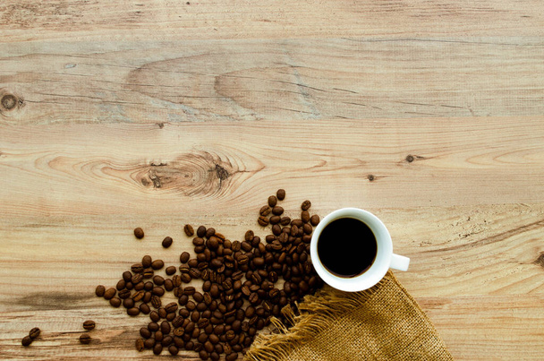Coffee cup with coffee bag on wooden background. View from top. - Фото, изображение