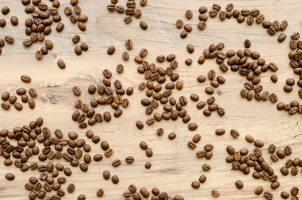 Coffee aromatic beans on wood background. Top view. - Photo, Image