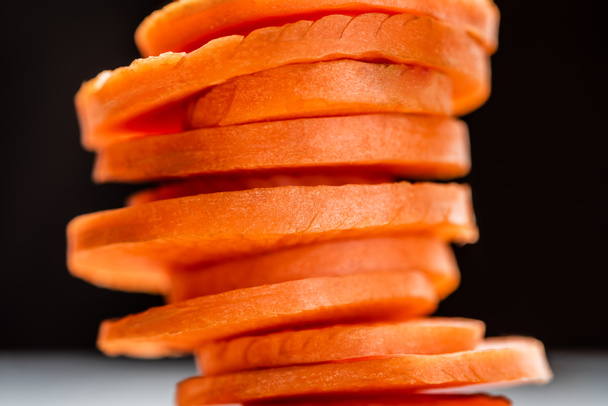 close up view of fresh ripe carrot slices isolated on black - Fotoğraf, Görsel