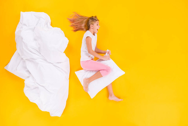 Top view above high angle flat lay flatlay lie concept of her she nice cheerful cheery girl insomnia riding pillow having fun isolated on bright vivid shine vibrant yellow color background - Photo, Image