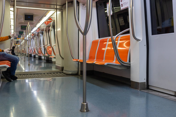 Rome, Italy - April 30, 2020: Inside the metro of line A the seats remain empty due to the quarantine imposed by the coronavirus emergency. Few passengers traveling. - Фото, зображення
