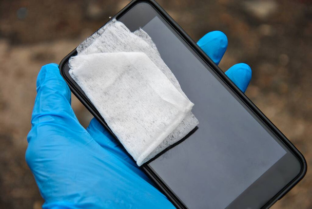 smartphone disinfection with a wet wipe - Photo, Image