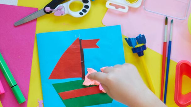 School supplies, stationery on yellow background - space for caption. Child ready to draw with pencils and make application of colored paper. Top view. - Foto, imagen