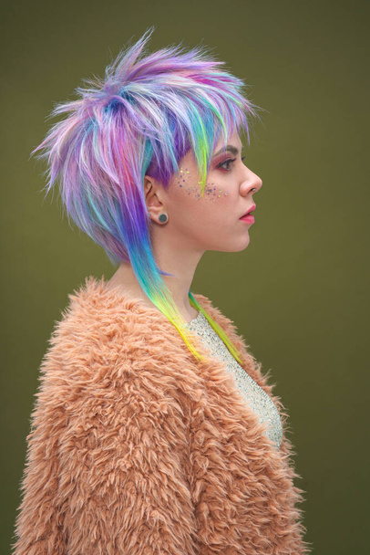 Portrait of a beautiful young girl with dyed colored hair. Hairstyle and makeup. Fashion shooting for the hairdresser colorist. - Фото, изображение