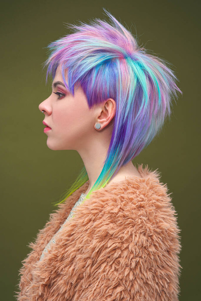 Portrait of a beautiful young girl with dyed colored hair. Hairstyle and makeup. Fashion shooting for the hairdresser colorist. - Foto, immagini