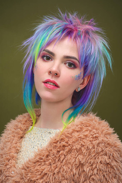 Portrait of a beautiful young girl with dyed colored hair. Hairstyle and makeup. Fashion shooting for the hairdresser colorist. - Фото, изображение