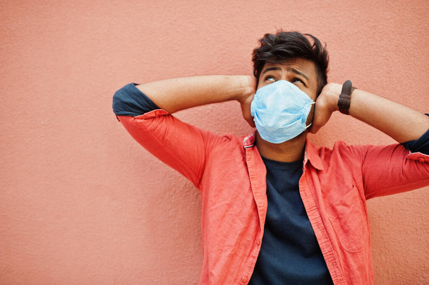 Coronavirus covid-19 concept. South asian indian man wearing mask for protect from corona virus isolated on pink background. - Φωτογραφία, εικόνα
