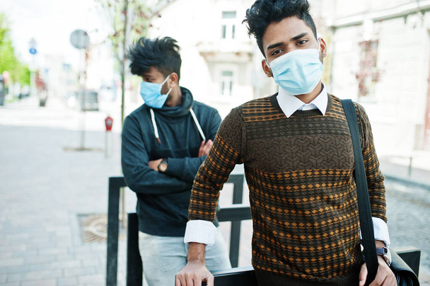 Coronavirus covid-19 concept. Two south asian indian man wearing mask for protect from corona virus. Social distance. - Photo, image