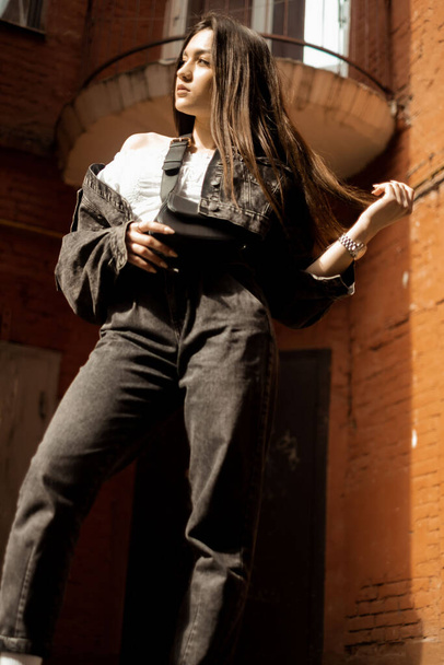 girl against a brick wall, bottom view - Фото, зображення