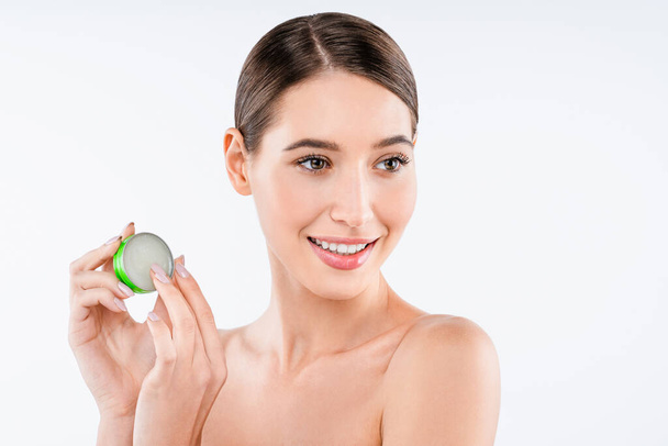 Young woman holding balm treatments lotion isolated over white background - Фото, зображення
