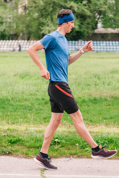 young guy runs morning stadium workout - Photo, Image