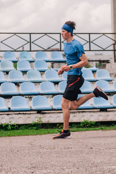 young guy runs morning stadium workout - Foto, Bild