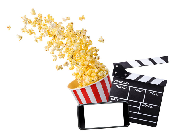 Flying popcorn, film clapper board and phone isolated on white background - Fotoğraf, Görsel