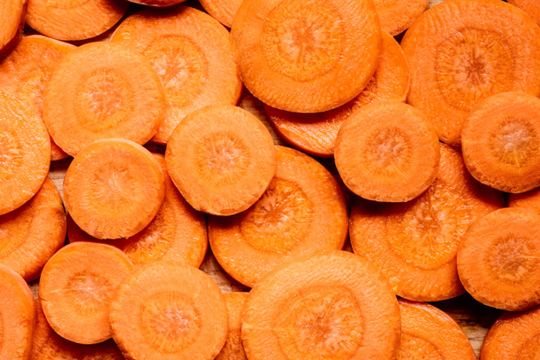 top view of fresh ripe carrot slices background - Photo, Image
