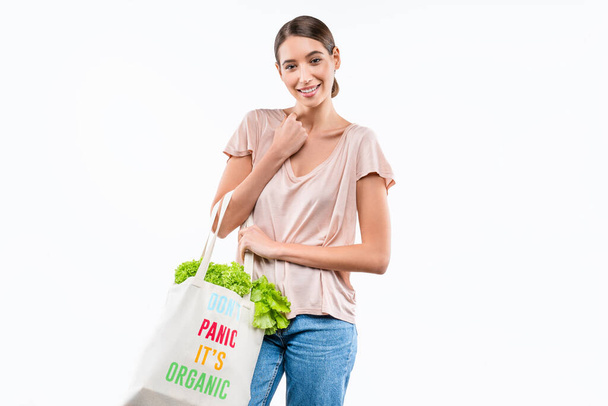 Young woman holding grocery shopping bag full of fresh vegetables isolated on white background. Healthy eating concept - Φωτογραφία, εικόνα