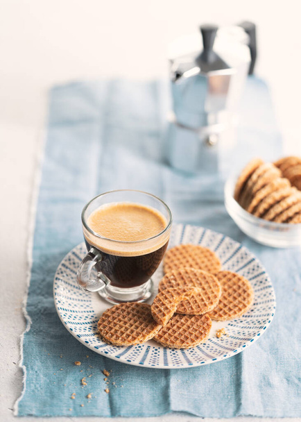 Dutch stroopwafel, caramel waffle and coffee over light background with copy space. Vintage style. - Fotografie, Obrázek