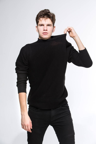Handsome Fashion Man In Black Sweatshirt Posing On White Background. Model Test. Mock-up Sweatshirt. Fashion and people concept. stylish trendy young man dressed in casual clothes posing in studio. - Foto, Bild