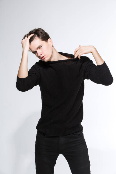 Handsome Fashion Man In Black Sweatshirt Posing On White Background. Model Test. Mock-up Sweatshirt. Fashion and people concept. stylish trendy young man dressed in casual clothes posing in studio. - Zdjęcie, obraz