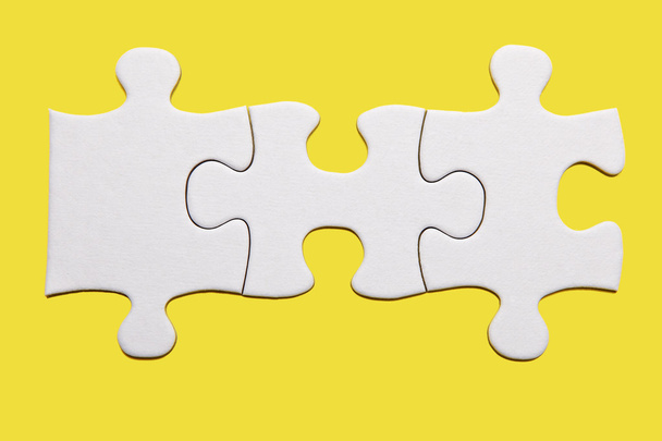 Three puzzle pieces on yellow - Valokuva, kuva