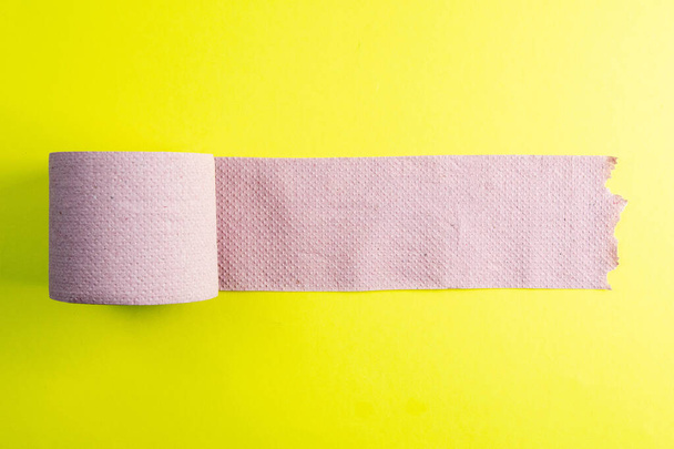 Rolls of toilet paper on a yellow background top view. - Valokuva, kuva