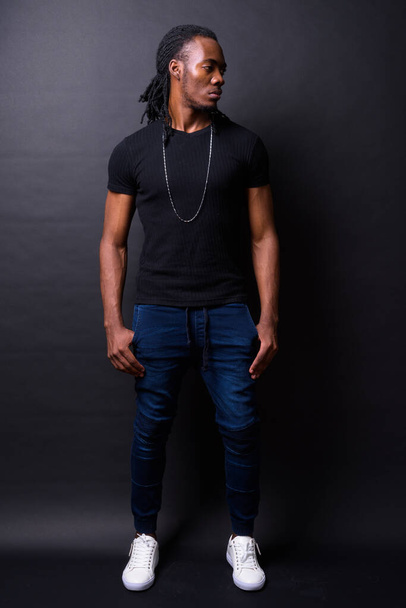 Full body shot of young handsome African man with dreadlocks - Zdjęcie, obraz