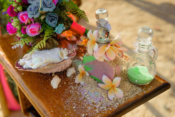 песчаная церемония на столе с красивым букетом цветов
 - Фото, изображение